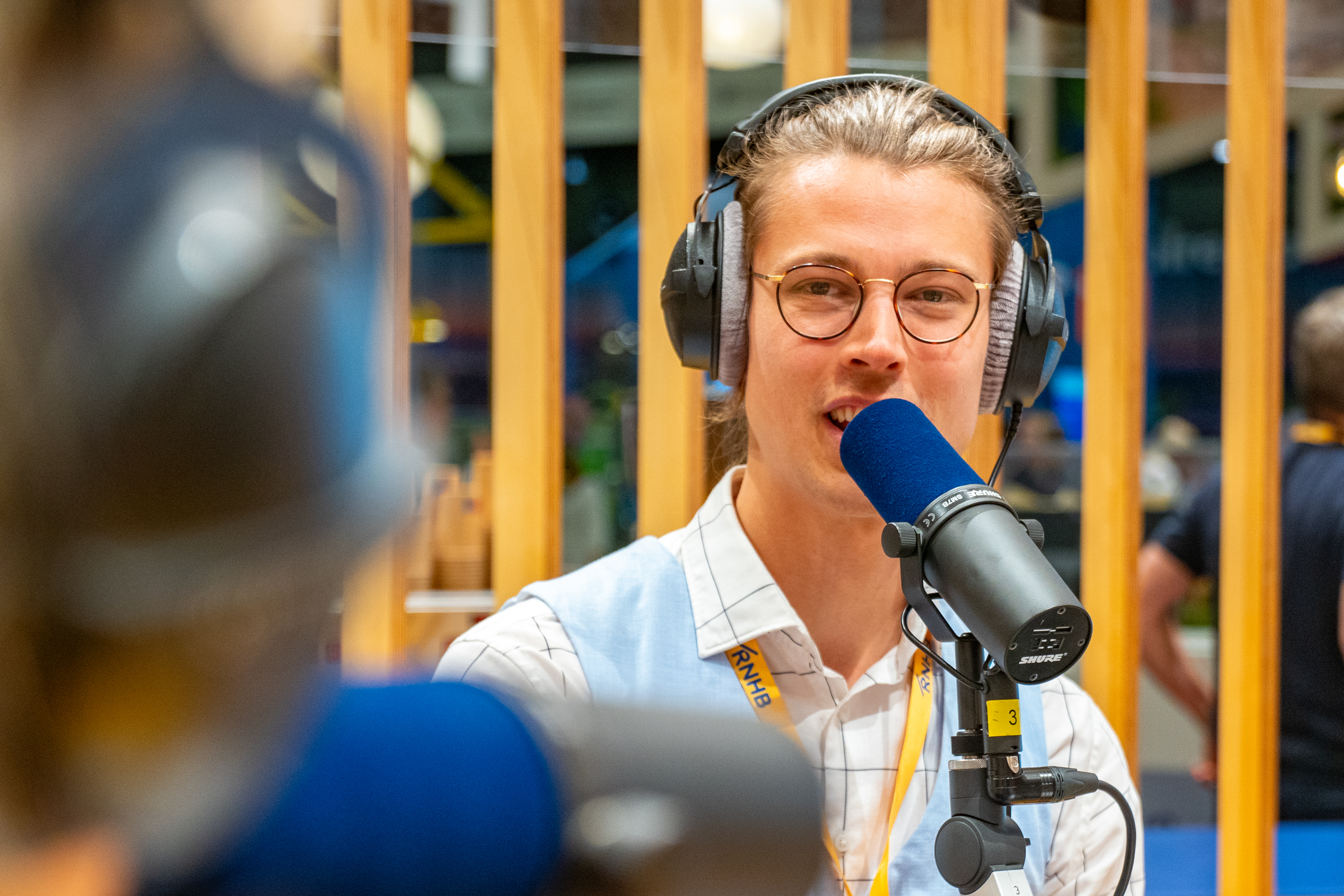 Thijs recording a podcast with headphones and a microphone